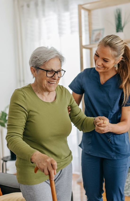 Smiling senior patient receiving care at home from a KindCare nurse